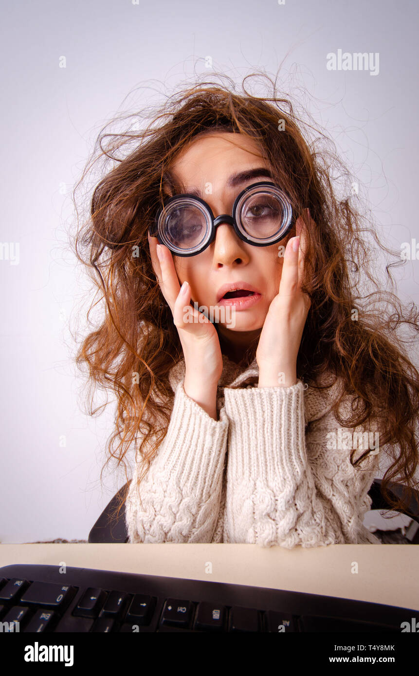 Funny nerd girl working on computer Stock Photo