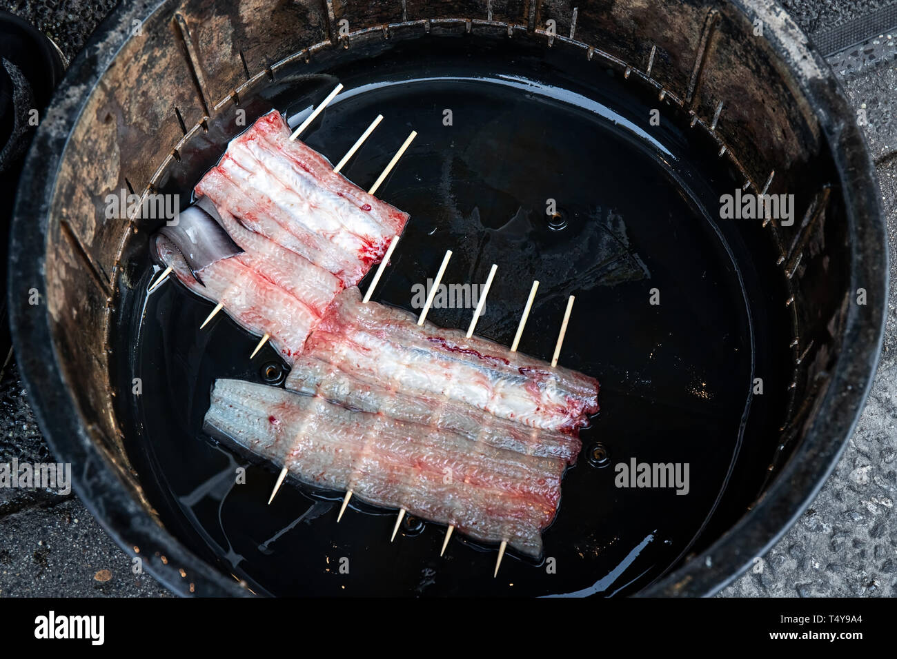 Freshly cleaned eels sit in a bucket at a local restaurant in Narita, Japan. Stock Photo