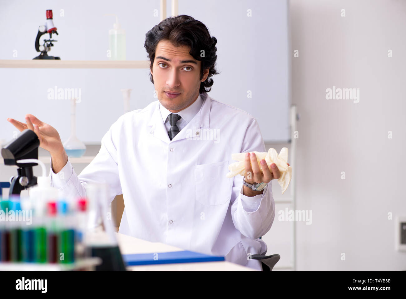 Young handsome chemist working in the lab Stock Photo - Alamy
