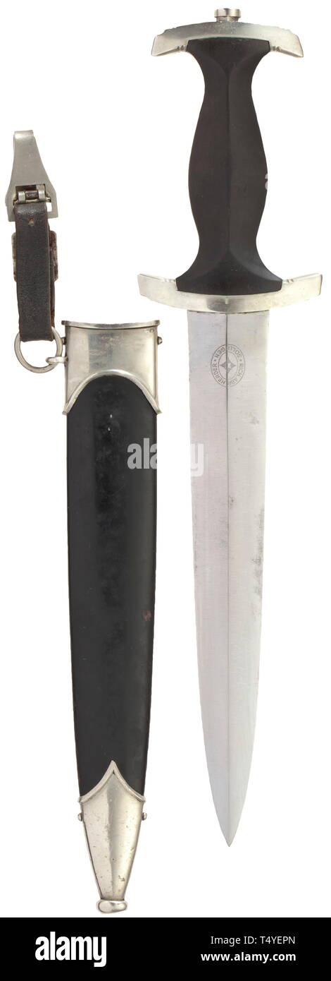 A service dagger M 33 with leather hanger. Good blade with etched devices, maker Rich. Abr. Herder, Solingen. Nickel silver grip fittings, the quillons punched 'I'. Black wood grip with inset nickel silver eagle and enamelled SS emblem, black painted steel scabbard with nickel silver fittings (the terminal button of scabbard pushed in), the leather hanger with part of the vertical hanger. Length circa 37 cm. historic, historical, 20th century, 1930s, 1940s, Waffen-SS, armed division of the SS, armed service, armed services, NS, National Socialism, Nazism, Third Reich, Germa, Editorial-Use-Only Stock Photo