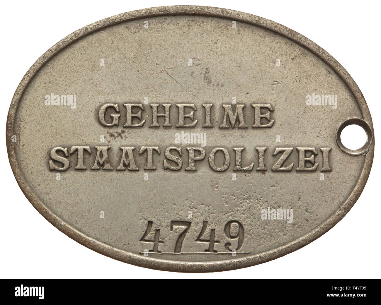 An identity badge of a GESTAPO member. Oval badge of nickel silver, the obverse with a raised national eagle, reverse raised lettering 'GEHEIME STAATSPOLIZEI', below this the struck number '4749' on a raised line. Without chain for wear. Dimensions 37 x 51 mm, weight ca. 25 g. historic, historical, 20th century, Additional-Rights-Clearance-Info-Not-Available Stock Photo