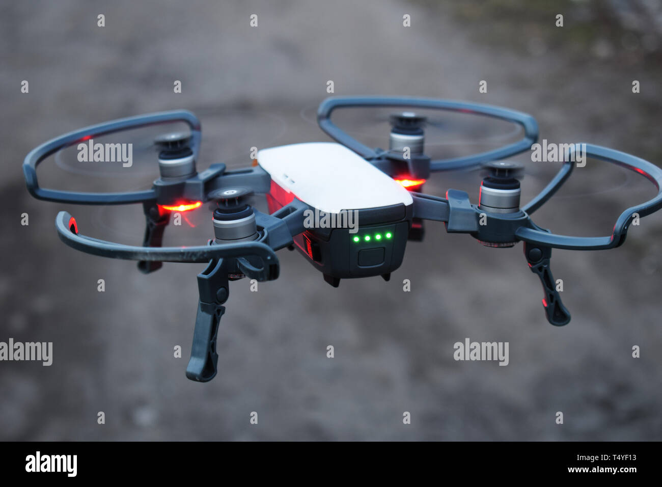 A drone with a red backlight is preparing for takeoff, new technologies in aerial photography. Stock Photo