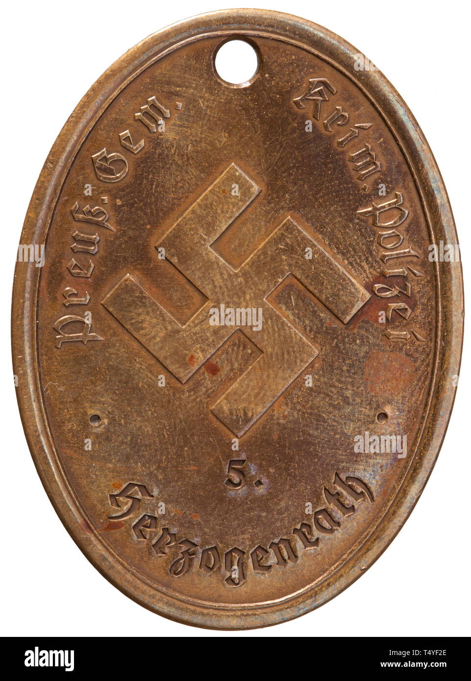 An identity disc of the Prussian communal criminal police of Herzogenrath. Bronze, the obverse with a stamped Prussian eagle and national emblem surmounted by the motto 'Gott mit uns'. The reverse with raised characters 'Preuß. Gem. Krim. Polizei' beneath which is struck 'Herzogenrath' surmounted by a struck '5.' flanked by delimiting points, the centre with a raised swastika. Dimensions 37 x 51 mm, weight 29.7 g. A very rare badge. historic, historical, 20th century, Additional-Rights-Clearance-Info-Not-Available Stock Photo