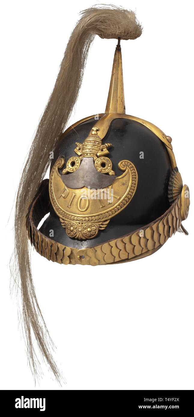 A guard's helmet, mid-19th century. Black lacquered leather skull, metal mounts of gold-plated non-ferrous metal. Emblem with papal insignia and relief inscription 'Pius IX' on finely embossed ground. Flat chinscales. Gold-plated spike with bright horse-hair plume (trimmed). Green leather lining on the undersides of both peaks, black leather sweatband (damaged), 'Stapa XII' written on the inside of the skull. Signs of wear and age. Very rare. historic, historical, 19th century, Additional-Rights-Clearance-Info-Not-Available Stock Photo