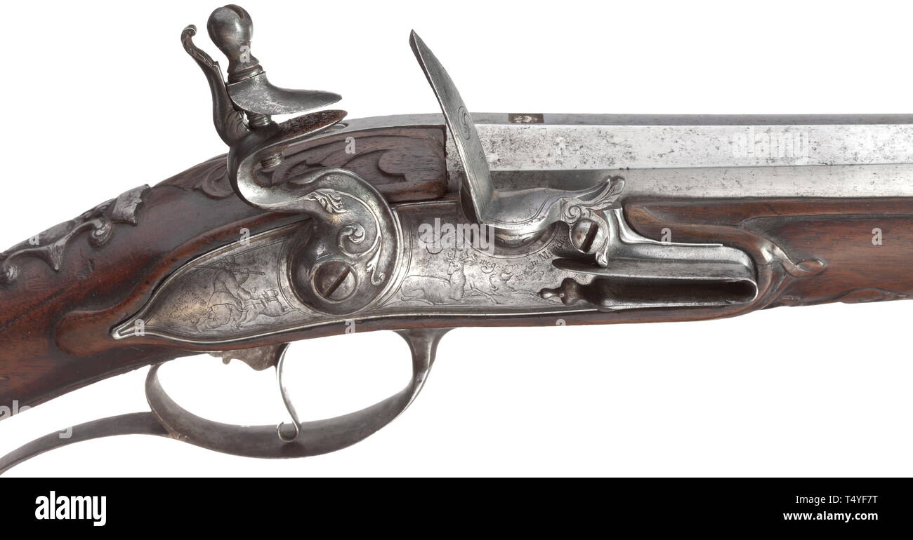 A flintlock rifle, Hans Steinweg in Munich, circa 1690. Octagonal barrel with rifled bore in 16 mm calibre, silver-filled mark crown/'CAM' on top. Flintlock with finely cut hammer, the lockplate with hunt-ing-themed engravings. Carved full stock with chiselled and engraved iron furniture, the escutcheon with noble coat of arms. Wooden ramrod. Length 139 cm. Cf. Heer, Der Neue Stöckel, vol. 2, p. 1219. Extraordinarily beautiful, early flintlock rifle. historic, historical, civil long guns, gun, weapons, arms, weapon, arm, 17th century, Additional-Rights-Clearance-Info-Not-Available Stock Photo