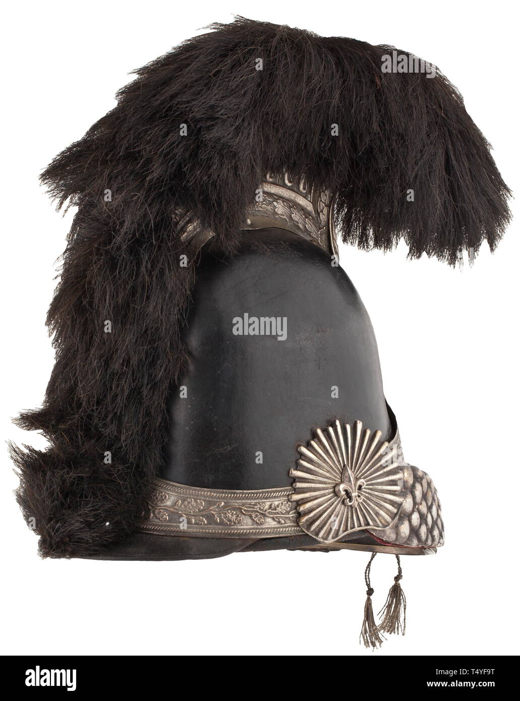A helmet for horsemen of the National Guard, model of 1814 - 1820. Two-piece, black painted leather skull with silvered copper fittings, the screw-affixed emblem with a crowned lily appliqué. The high comb is likewise silvered and in fine relief with a black fur crest. Chinscales with velvet underlay and lacing, the rosettes likewise with a lily symbol. Silver-trimmed leather peak, the leather liner with slight damage. With a non-original white hair brush. Signs of usage and age. Height ca. 34 cm. Cf. Tavard, Casques et Coiffures Militaires Franc, Additional-Rights-Clearance-Info-Not-Available Stock Photo