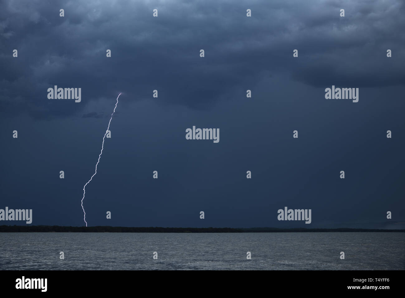 Thunderstorm with thunderbolt over a lake Stock Photo - Alamy