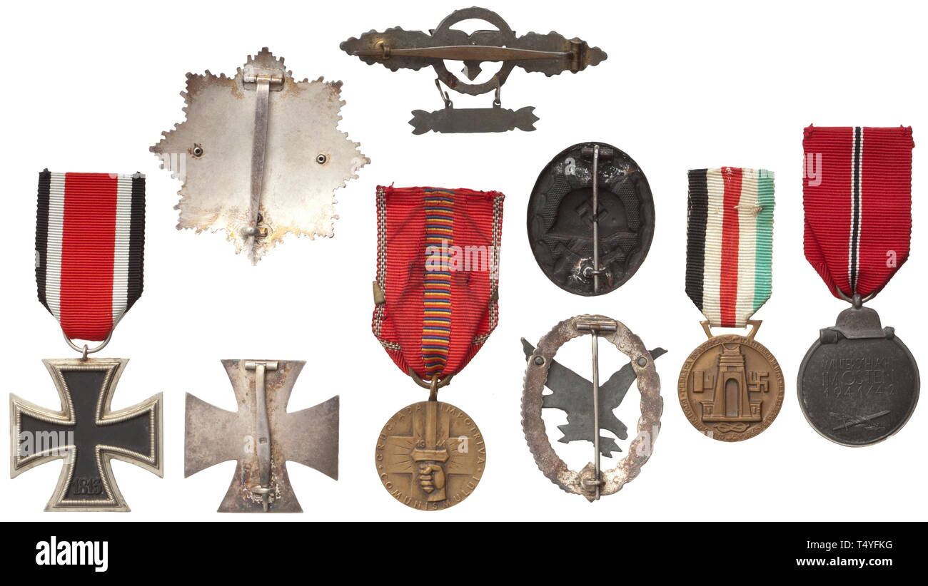 Awards and documents of a transport flyer. A German Cross in Gold, light issue with four rivets, the pin punched '20' on the underside, and large decorative document (folded, knocked) dated 5 December 1944 with blind-stamped Reich marshal eagle. Also an award document for the Goblet of Honour for Outstanding Achievement in the Air War dated 30 August 1943, and an award document for the Squadron Clasp in Gold for Transport Flyers dated 15 June 1942. Included are a Squadron Clasp in fine zinc issue (migrated) with '300' pendant as well as an Iron C, Additional-Rights-Clearance-Info-Not-Available Stock Photo