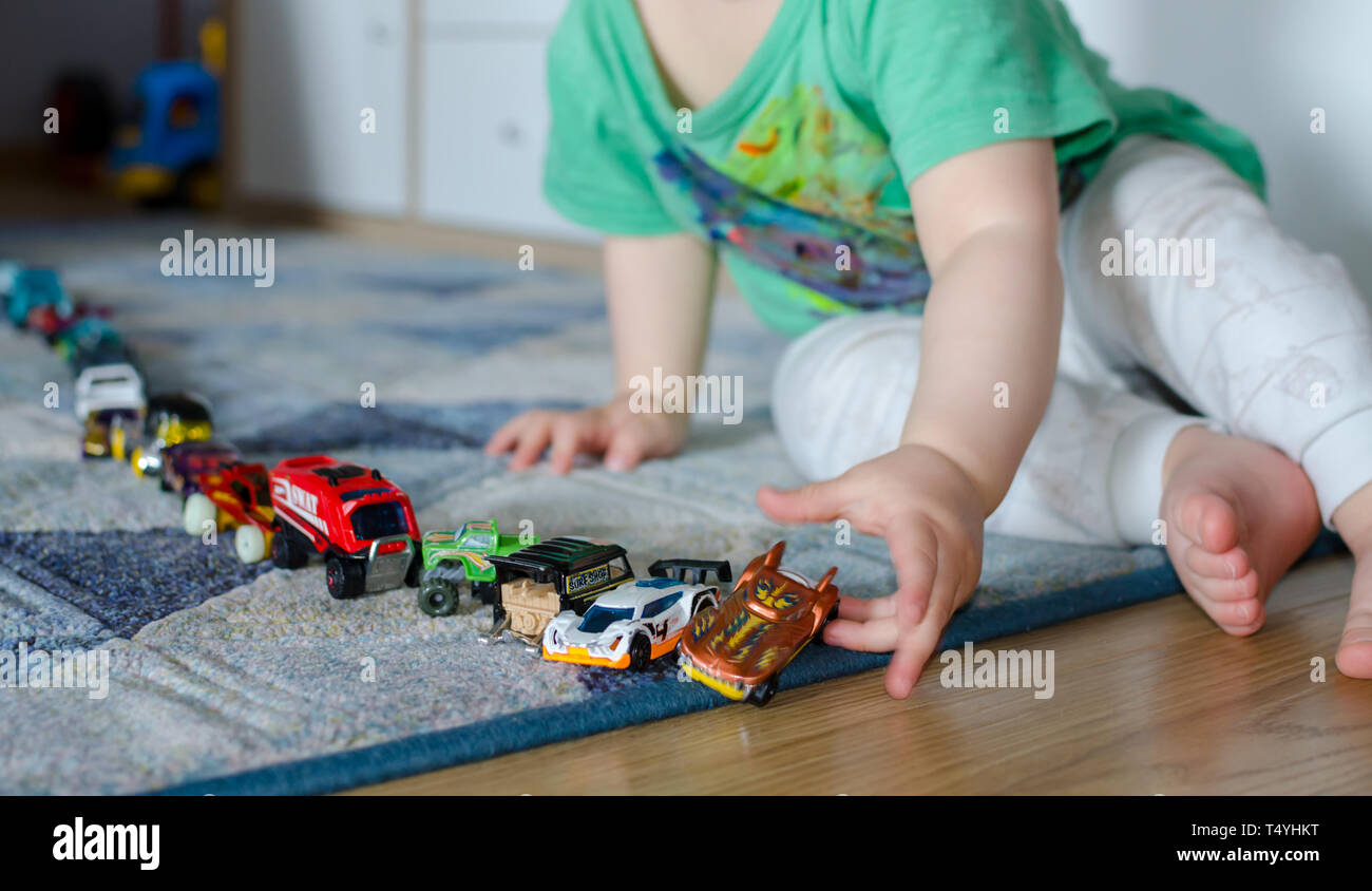 child lining up toys