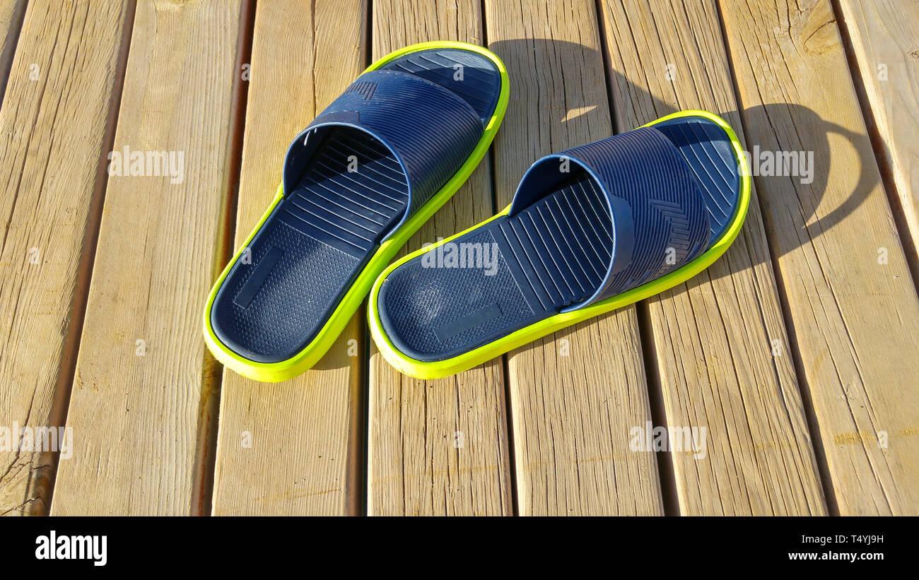 Pair of slippers on wooden background, macro shot Stock Photo - Alamy