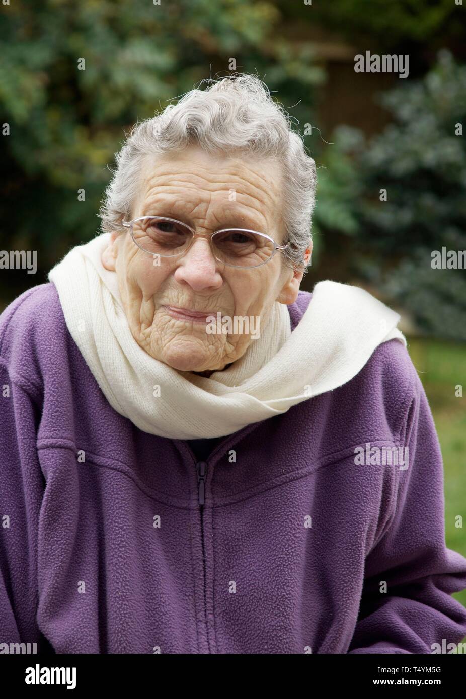 Elderly woman feeling very cold due to freezing temperatures Stock Photo