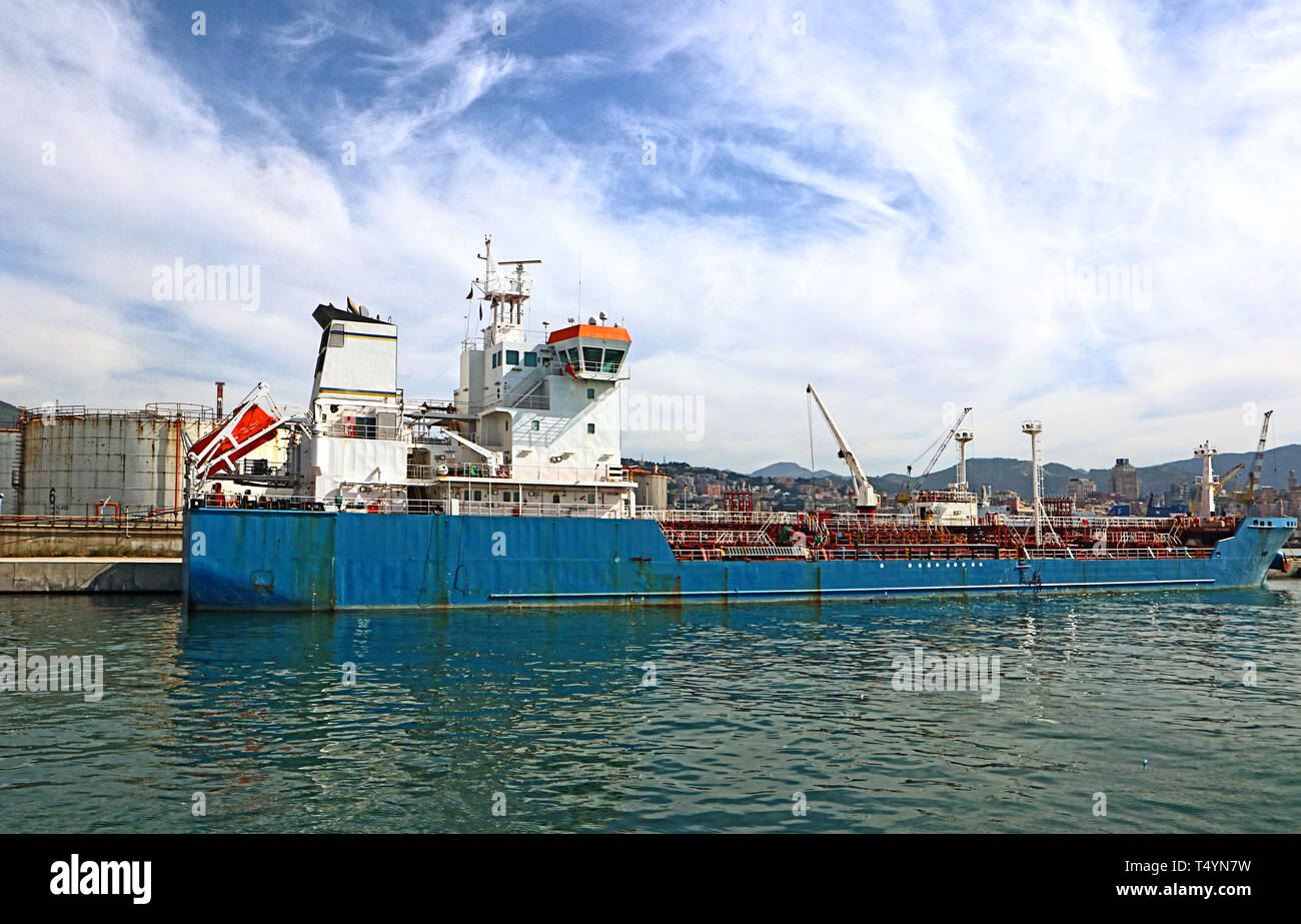 Genoa harbor: a tankship moored at the oil terminal near the gasometers Stock Photo