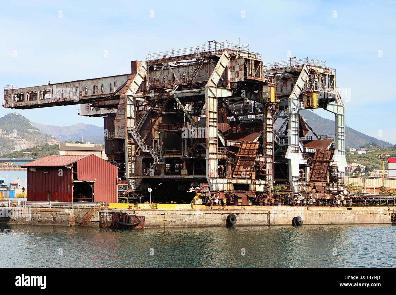 Genoa harbor, Italy - Rusty industrial structures at the container port terminal Stock Photo