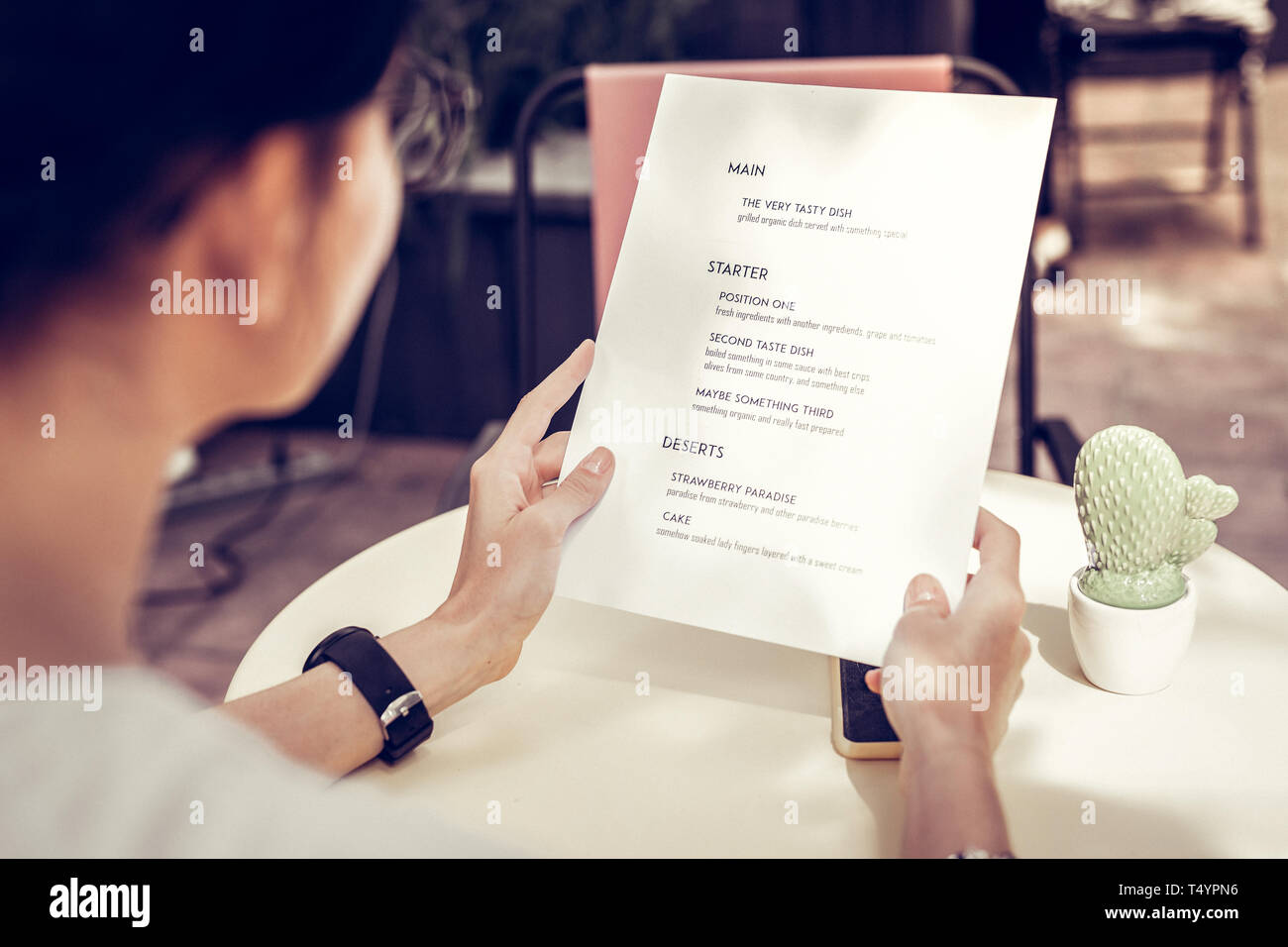Close up of a menu being in female hands Stock Photo