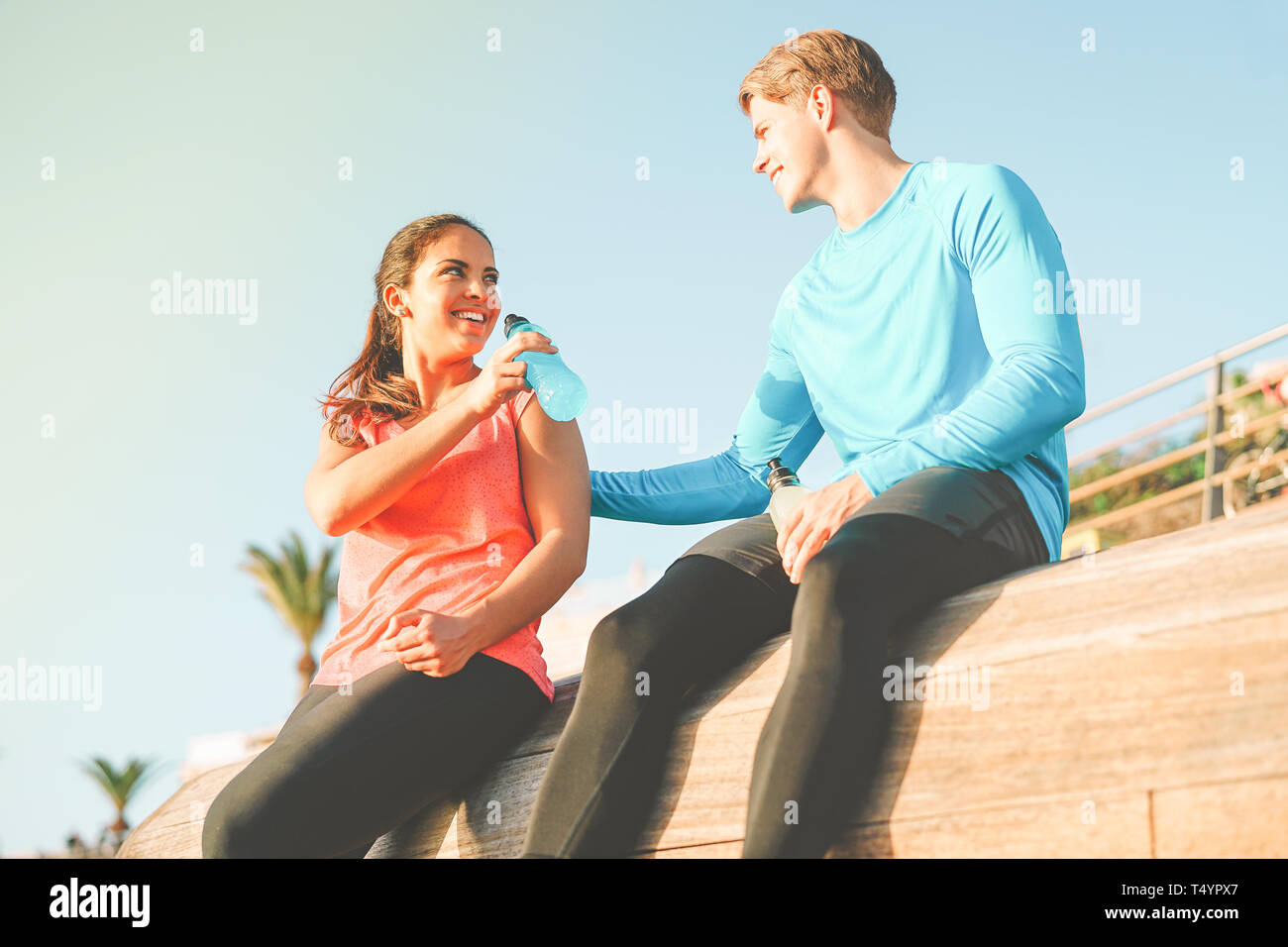 Health young couple having a break after jogging Sporty friends