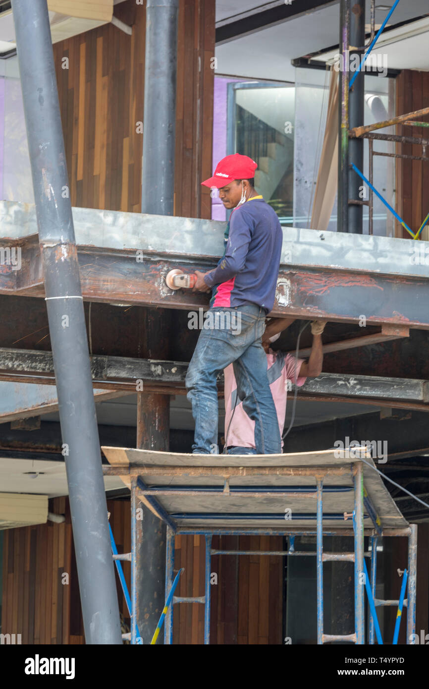a man working on some scaffolding in thailand working at height without any consideration for