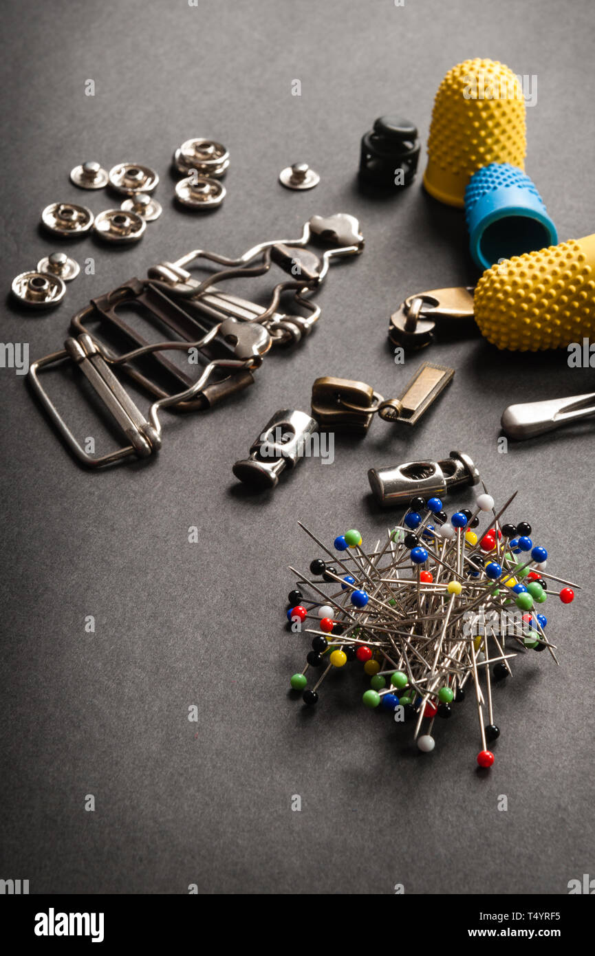 thimble and sewing pins on dark backdround Stock Photo