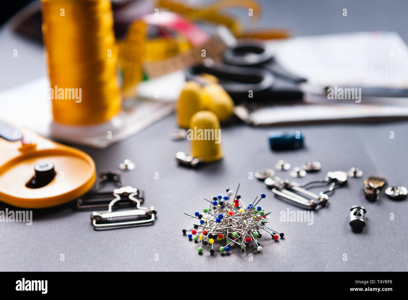 thimble and sewing pins on dark backdround Stock Photo