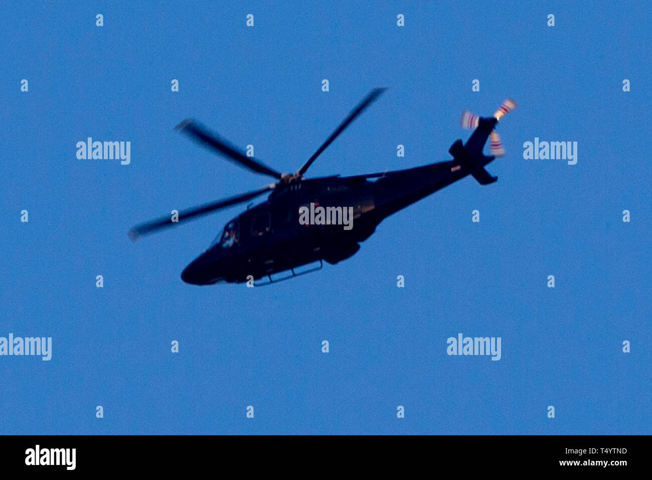 Agusta,Helicopter,seen through,heat,haze,flying,blue,sky,Isle of Wight, England, UK, Stock Photo