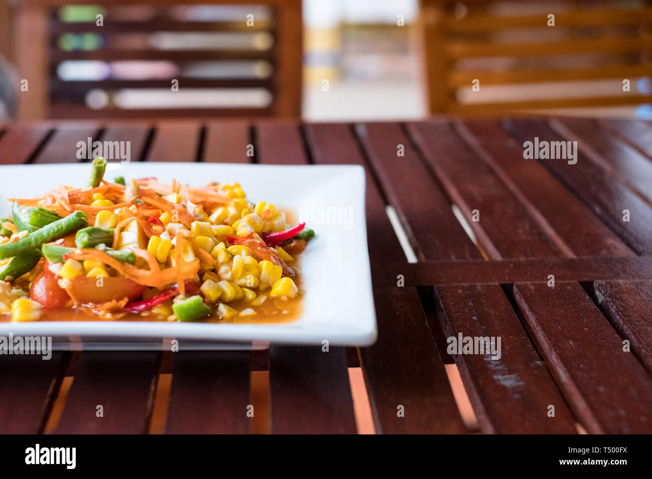 Corn seeds with fruits and vegetables sour spicy in white plate Stock Photo