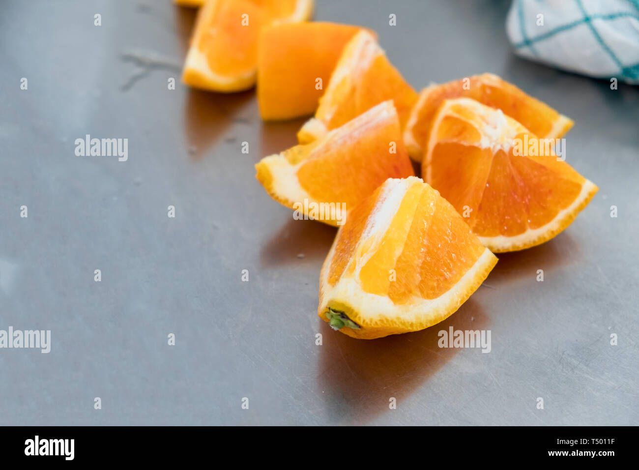 Ripe oranges slices on stainless table Stock Photo