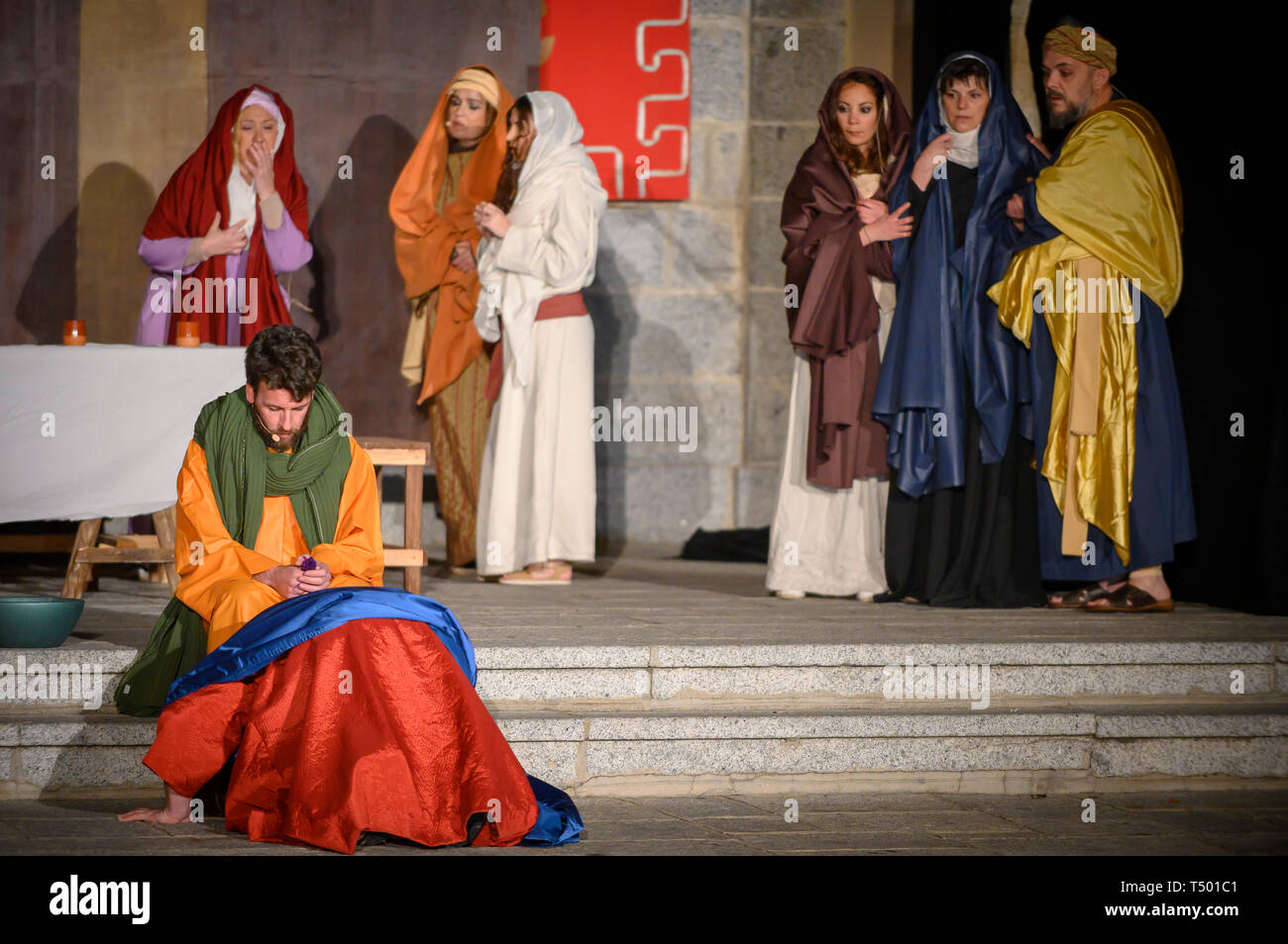 Brunete, Spain - April 11, 2019: Popular play of The Passion of Christ in the Plaza Mayor of the town. Jesus washes and kisses the feet of Judas. Stock Photo
