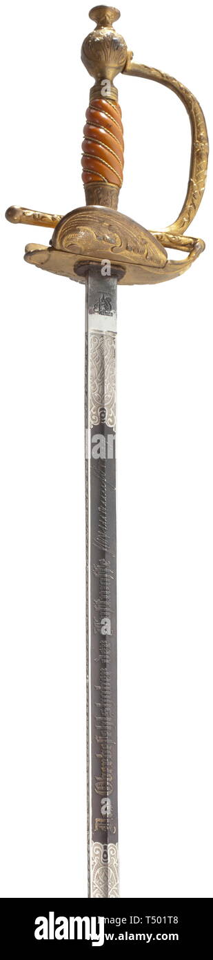 A small-sword for generals of the Luftwaffe. Fullered single-edged blade with double-edged tip, finely etched tendrils and inscriptions (the gilding and bluing now only barely visible): the obverse with 'In dankbarer Anerkennung', on the reverse 'Der Oberbefehlshaber der Luftwaffe Hermann Göring', the ricasso with the maker's logo of Eickhorn, Solingen. Gilt knuckle-bow hilt with a floral- and tendril décor in relief. Two foldable guard plates, the obverse with an applied silver Luftwaffe eagle. Orange-coloured plastic grip with gilt wire wrap. B, Additional-Rights-Clearance-Info-Not-Available Stock Photo