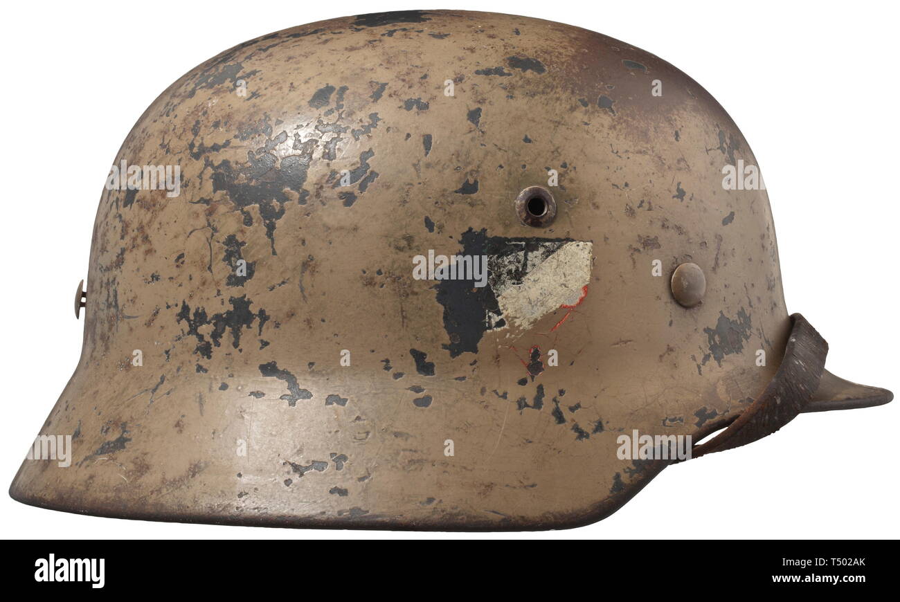 A steel helmet M 40 Afrika Korps - Division "Hermann Göring". The helmet  with original desert camouflage paint, two decals underneath. Ventilation  holes stamped concurrently, the helmet edge turned-under. With brown inner