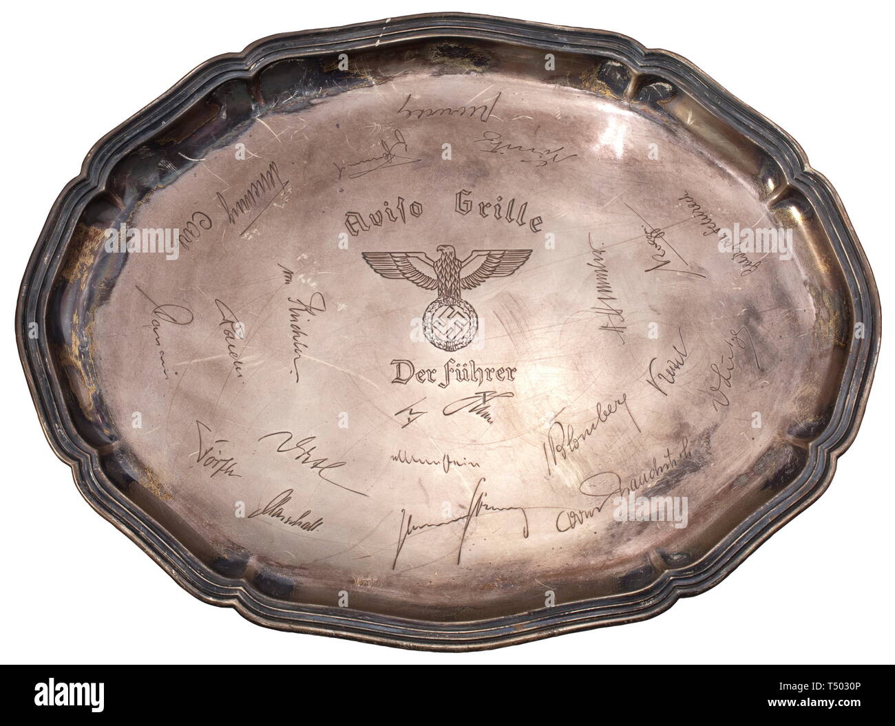 Aviso Grille - Adolf Hitler - a guest tray and a board coat of arms. Large-format silver tray, a present for the mess rooms of Adolf Hitler's personal yacht. A centrally located national eagle with inscribed name of the ship as well as the designation "Der Führer", engraved with more than 20 autographs of many senior officers and personalities, including Himmler, Keitel, v. Brauchitsch, Blomberg, Raeder, Lutze and many others. The reverse with a modern hanger and silver punches "830S" and "C.Mich.". Dimensions 42 x 32 cm. Further, the ship's coat of arms made of fired clay,, Editorial-Use-Only Stock Photo