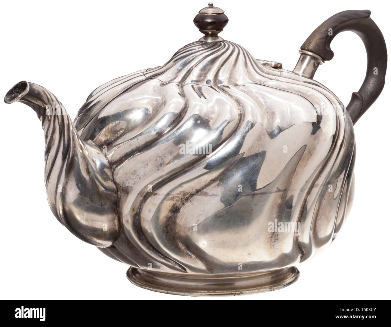 A silver teapot Augsburg, circa 1785. Round, richly gadrooned body (slightly dented). Hinged lid on a small, flared foot. Wooden knob, original wooden handle. On the bottom the city coat of arms of Augsburg with year letter 'C' (1785 - 87), master's mark 'SC' and assayer's mark. Height 16.5 cm, weight 662 g. historic, historical, handicrafts, handcraft, craft, object, objects, stills, clipping, clippings, cut out, cut-out, cut-outs, 18th century, Additional-Rights-Clearance-Info-Not-Available Stock Photo