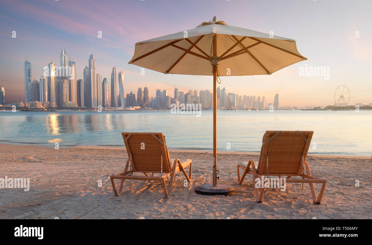 Beautiful Beach In Dubai With 2 Sun Chairs And An Umbrella In The