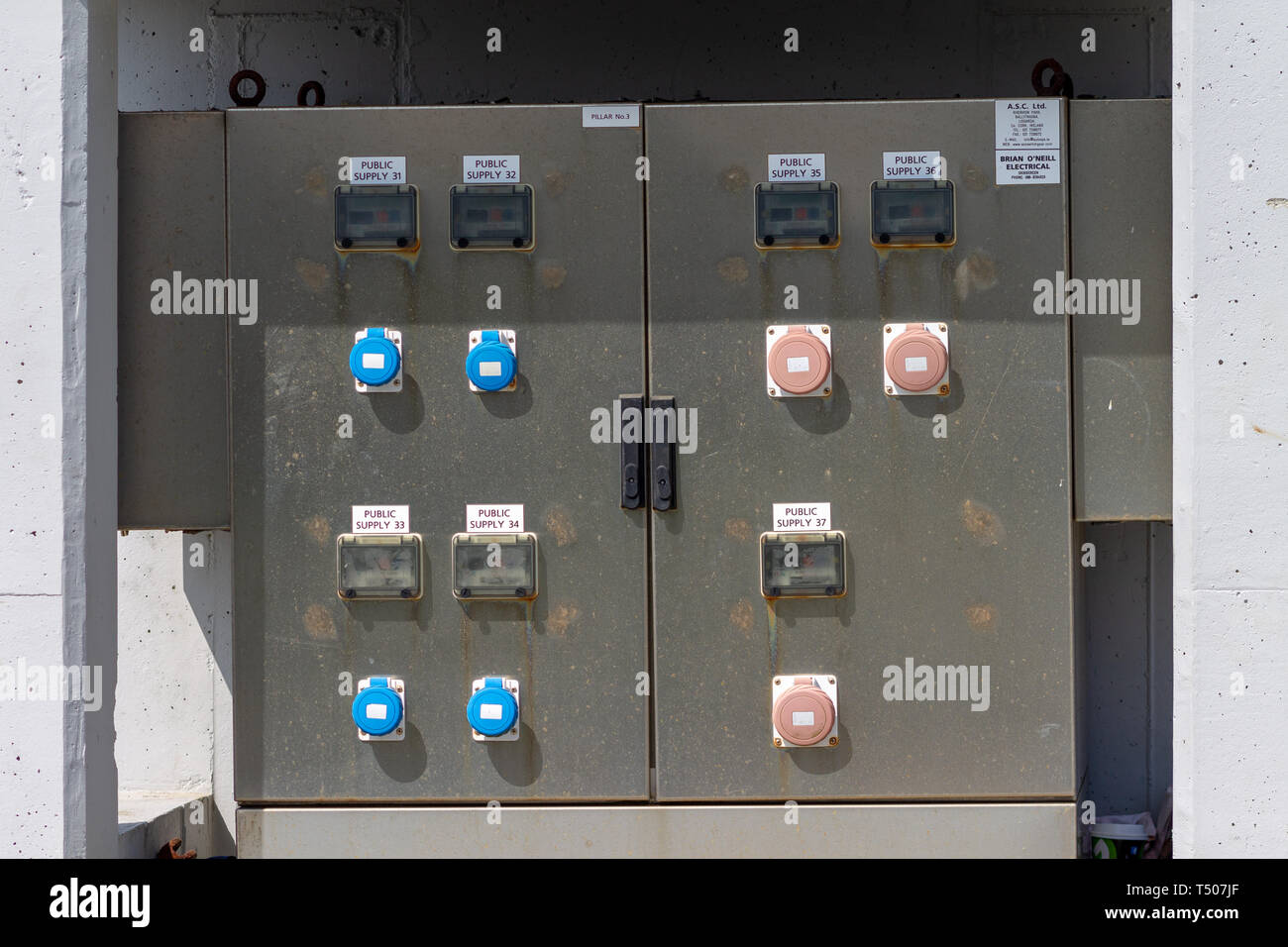 Outdoor weatherproof electrical plug sockets on an electrical distribution panel Stock Photo