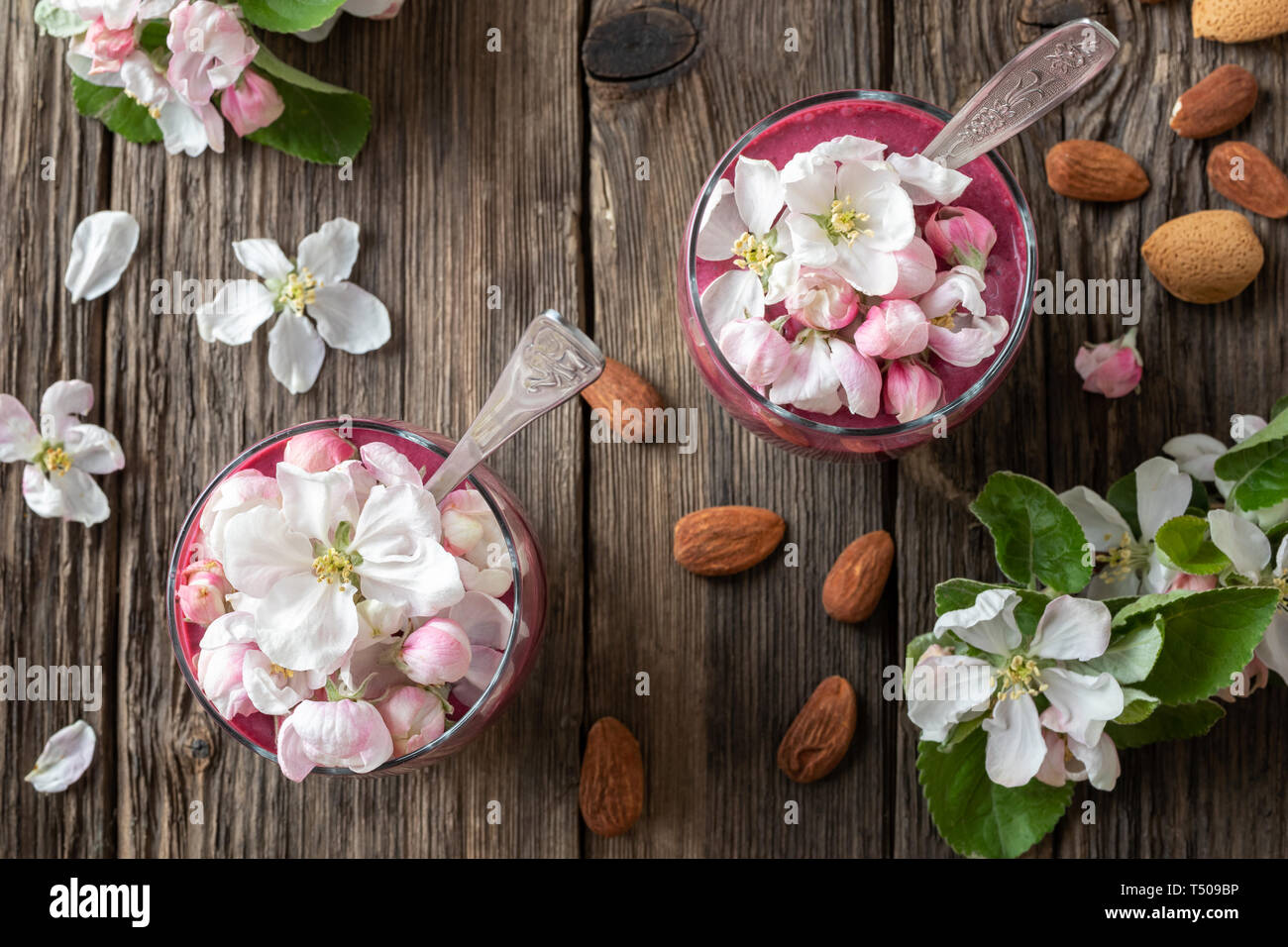Chia pudding with almond milk, yogurt, blueberries and apple blossoms, top view Stock Photo