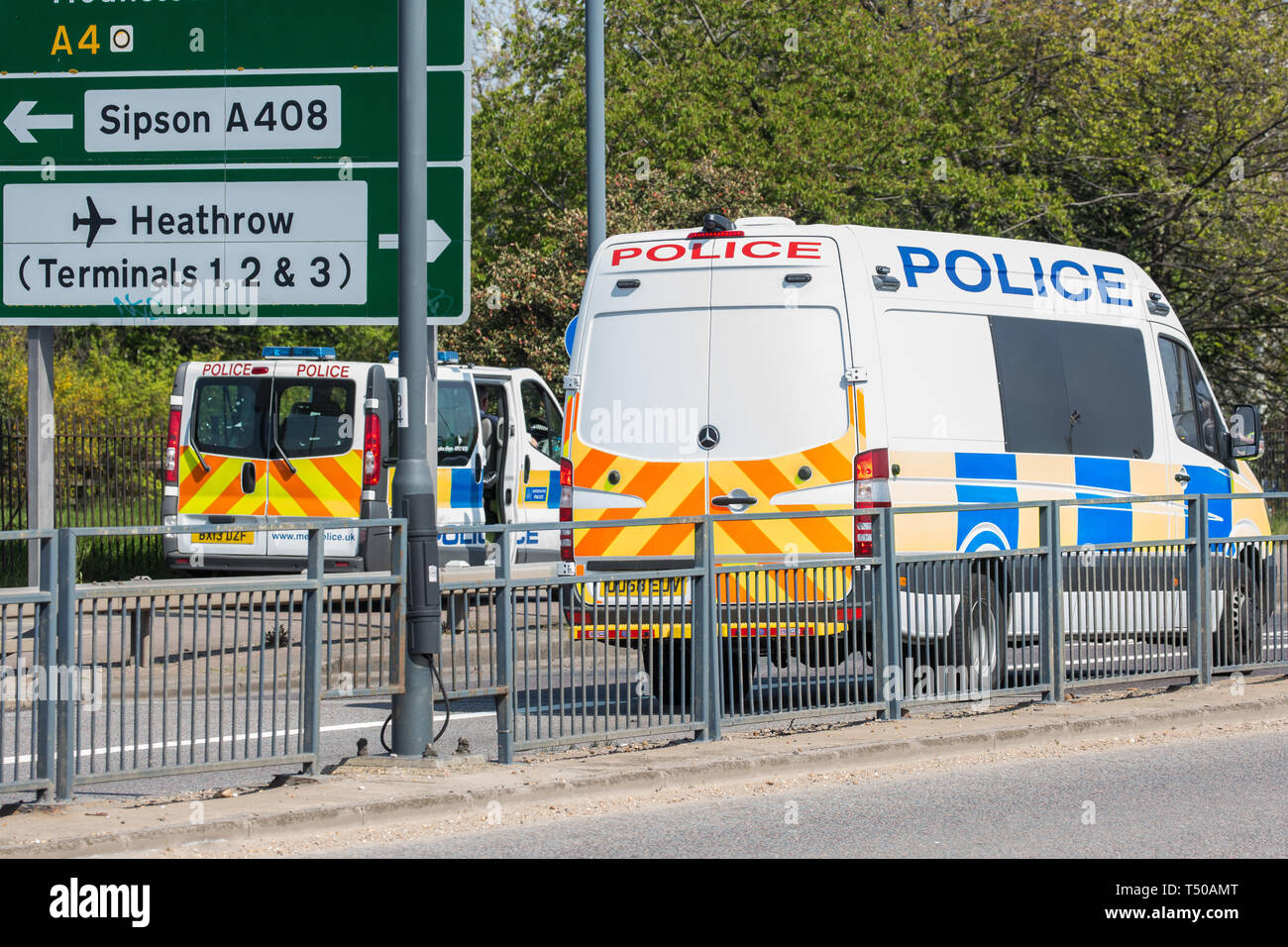 London, UK. 19th April, 2019. Police vehicles pass along the A4 outside Heathrow airport following a small protest earlier by Extinction Rebellion Youth. A large police presence is evident around the airport but so far any disruption feared by the airport authorities from Extinction Rebellion climate change activists has been symbolic rather than material. Credit: Mark Kerrison/Alamy Live News Stock Photo