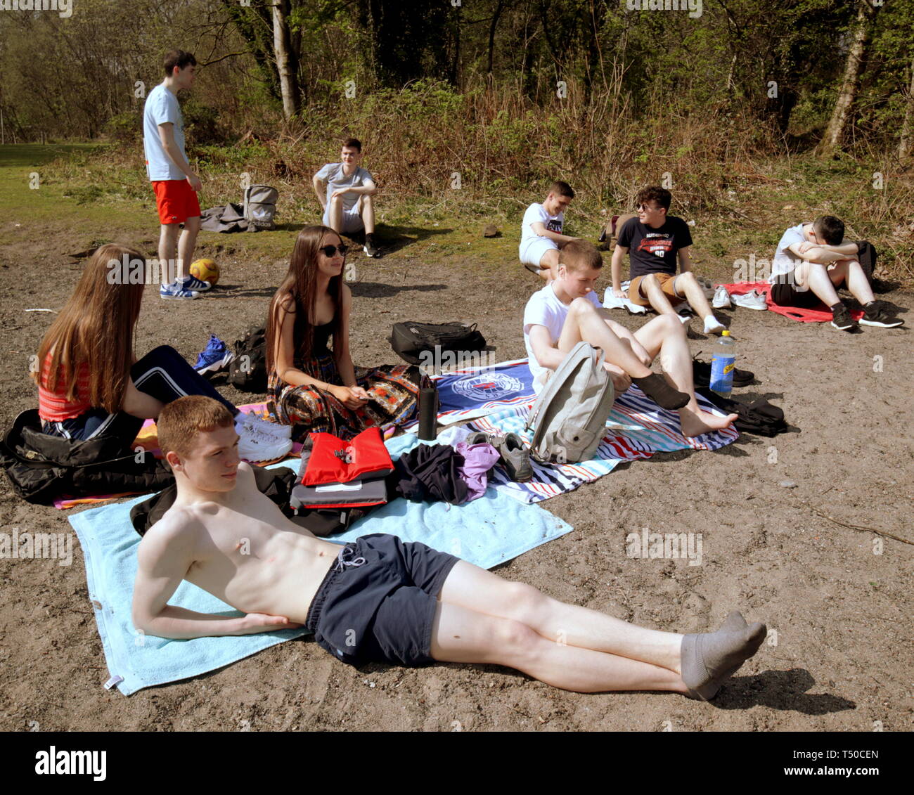 Glasgow, Scotland, UK, 19th April, 2019, UK Weather: Sunny summer good Friday as locals and tourists took the road to Loch Lomond as the temperatures rose as known locally as “Taps Aff” or tops off for non Gaelic speakers. School leavers from Dennistoun enjoy an end of school trip. Credit Gerard Ferry/Alamy Live News Stock Photo