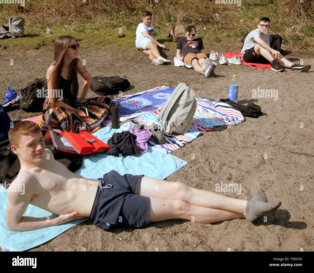 Glasgow, Scotland, UK, 19th April, 2019, UK Weather: Sunny summer good Friday as locals and tourists took the road to Loch Lomond as the temperatures rose as known locally as “Taps Aff” or tops off for non Gaelic speakers. School leavers from Dennistoun enjoy an end of school trip. Credit Gerard Ferry/Alamy Live News Stock Photo