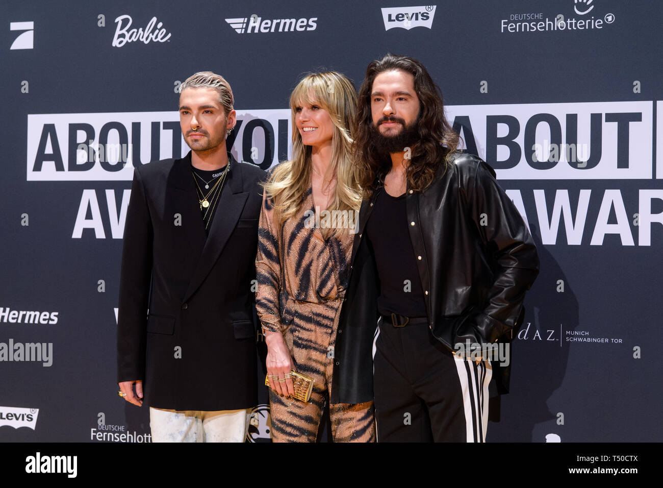 18 April 2019, Bavaria, Grünwald: Heidi Klum, model, businesswoman and  presenter of Germany's Next Topmodel (GNTM), her fiancé Tom Kaulitz, singer  of the band Tokio Hotel (r) and his twin brother Bill