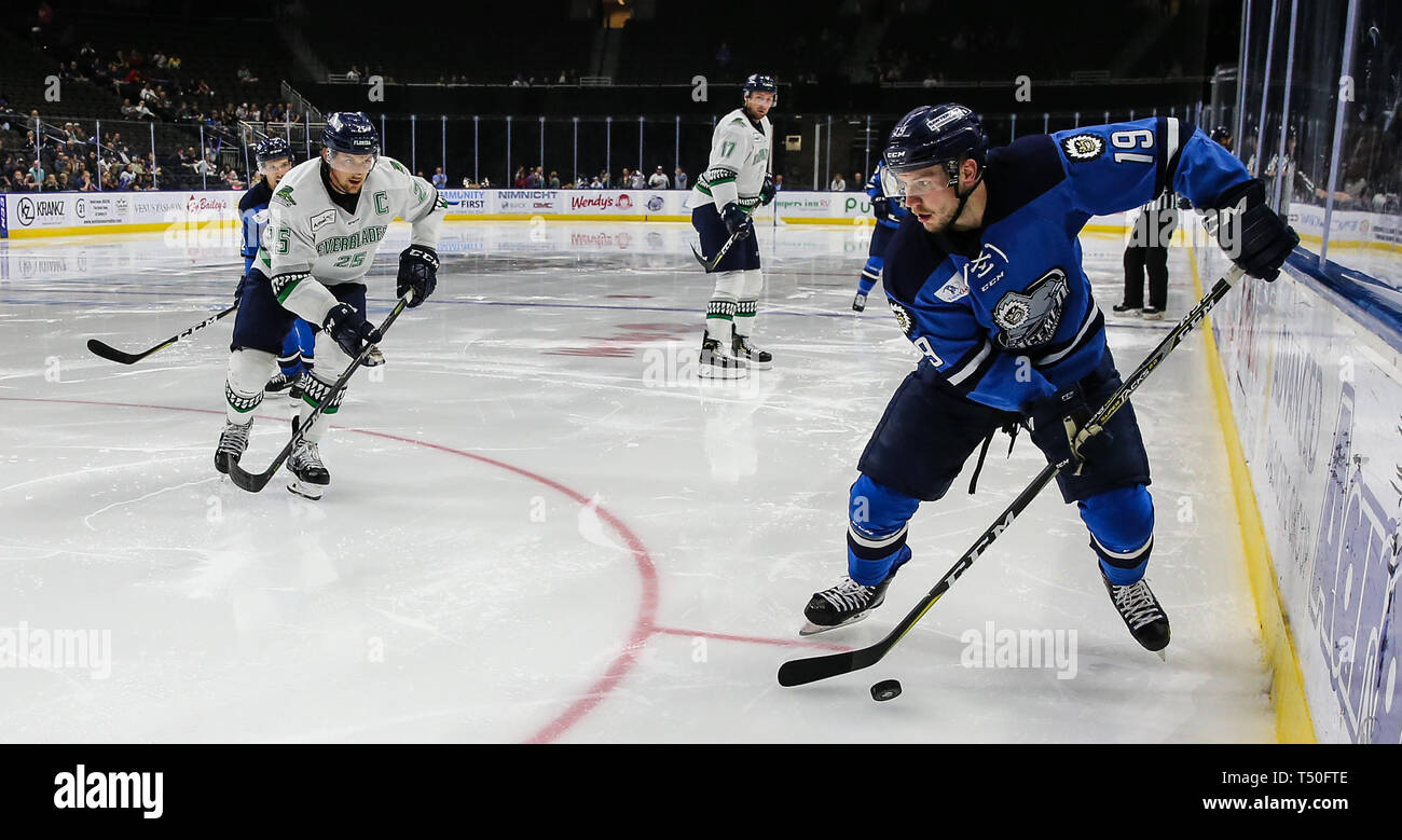 Jacksonville Icemen forward Cody Fowlie (19) advances the puck defended by Florida Everblades forward John McCarron (25), left, during the third period of an ECHL professional hockey playoff game at Veterans Memorial Arena in Jacksonville, Fla., Thursday, April 18, 2019. (Gary Lloyd McCullough/Cal Sport Media) Stock Photo