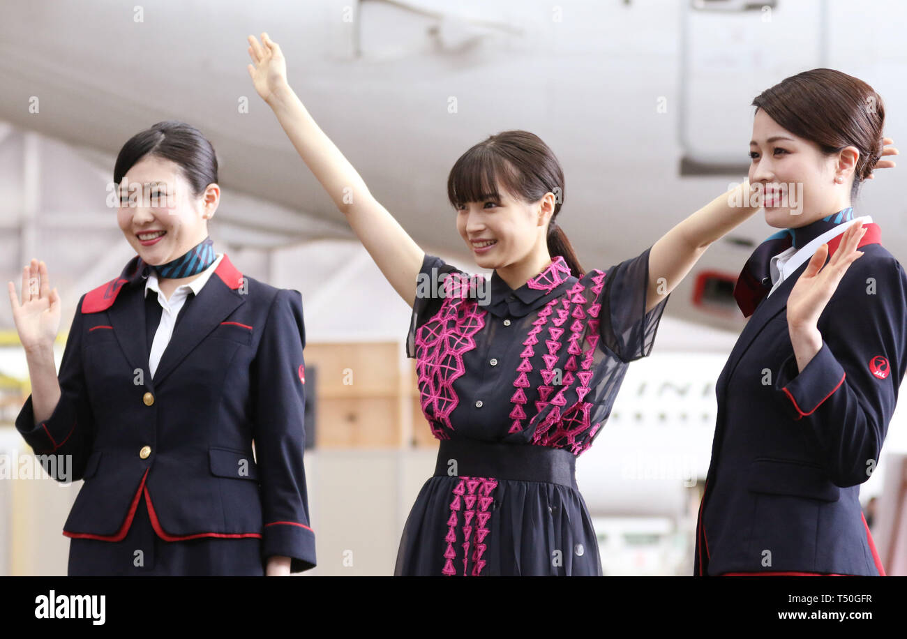 Tokyo, Japan. 19th Apr, 2019. Japanese actress Suzu Hirose smiles with  Japan Airlines (JAL) cabin attendants as JAL unveils a Boeing 737 plane  with decals of Hirose at a scene of her