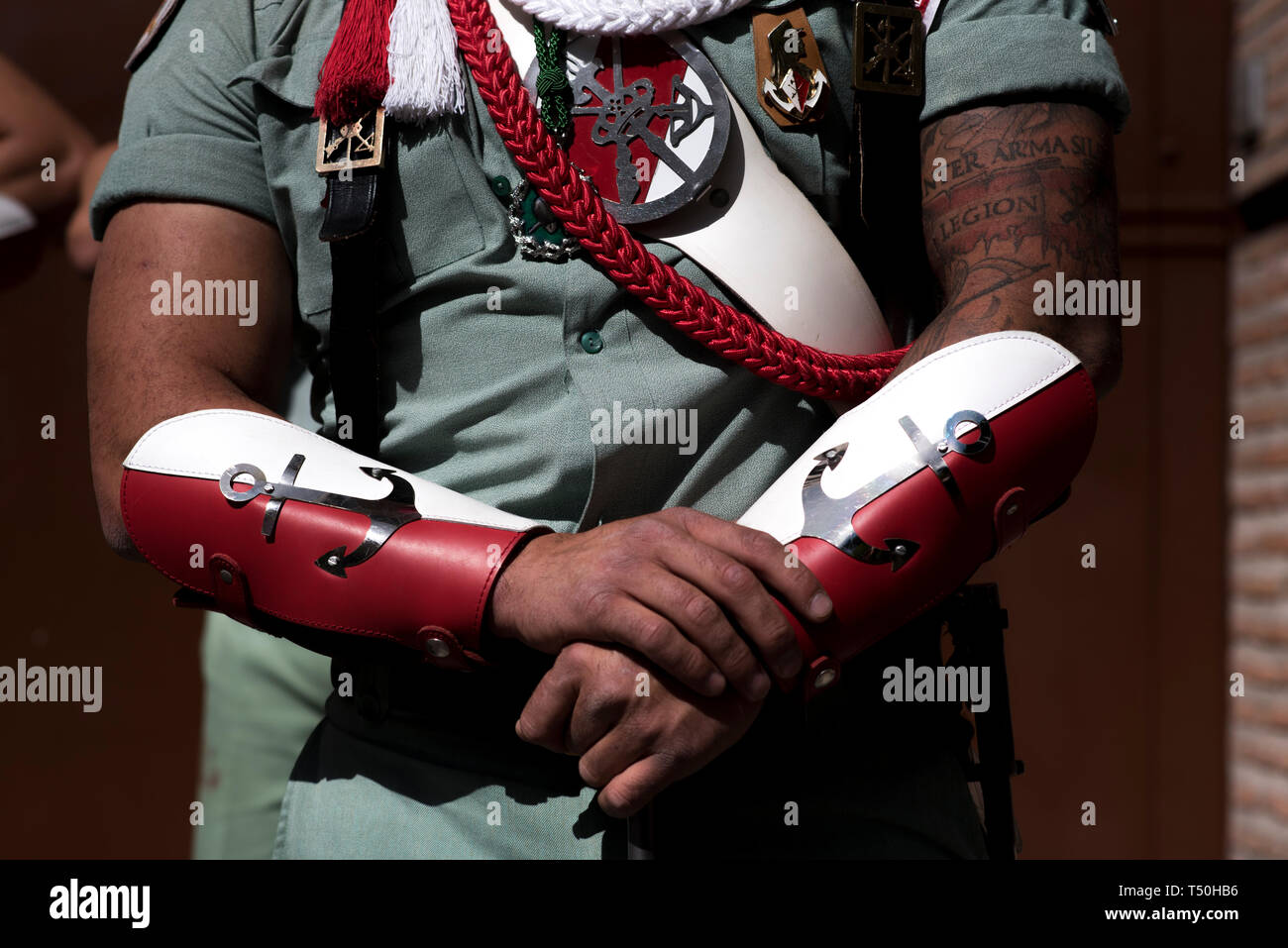 Soldier with a tattoo of the La Legion is seen during the Good Friday procession in Granada. Every year thousands of christians believers celebrates the Holy Week of Easter with the crucifixion and resurrection of Jesus Christ. Stock Photo