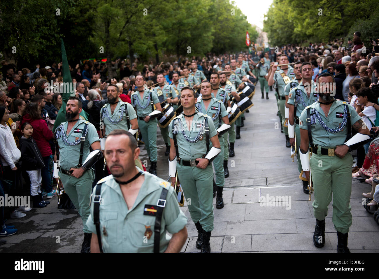 Soldiers of La Legion are seen marching during the Good Friday procession in Granada, Spain. Every year thousands of christians believers celebrates the Holy Week of Easter with the crucifixion and resurrection of Jesus Christ. Stock Photo