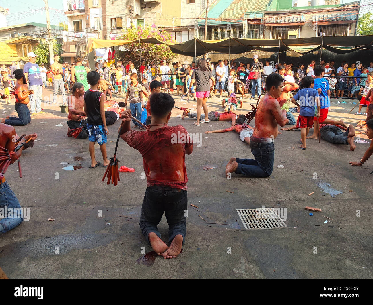 (EDITORS NOTE: Image contains graphic content) Flagellates seen whipping their backs at the front yard of the chapel during Good Friday. Devout catholics in the deeply religious southeast asian nation of the philippines show their faith on good friday with self-flagellation or self-inflicting wounds,  imitating the suffering of christ. Stock Photo