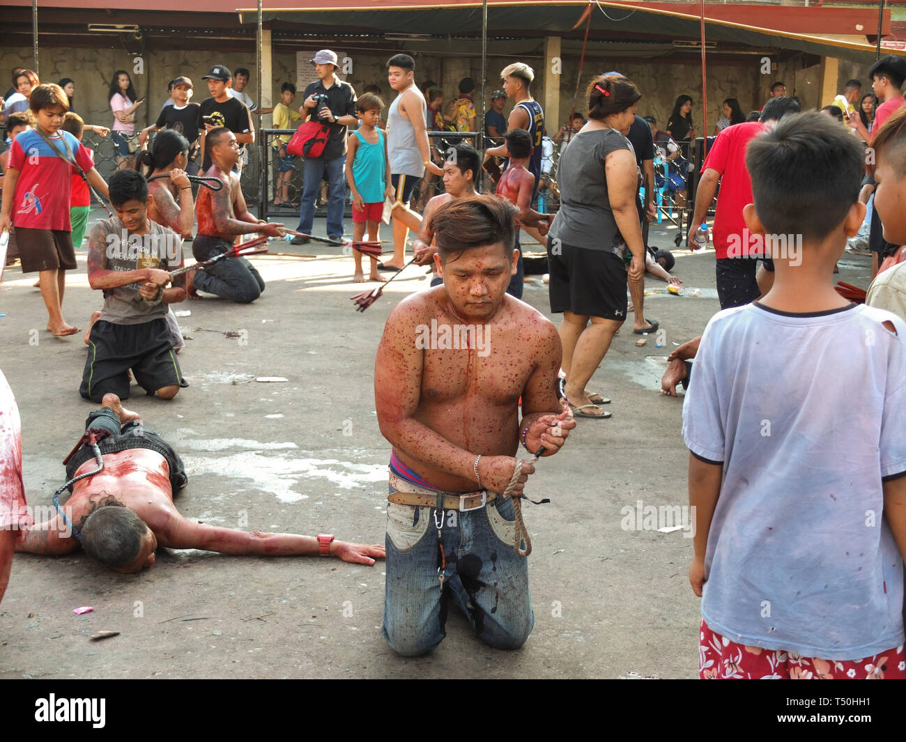 (EDITORS NOTE: Image contains graphic content) A flagellate seen full of drops of his own blood during Good Friday. Devout catholics in the deeply religious southeast asian nation of the philippines show their faith on good friday with self-flagellation or self-inflicting wounds,  imitating the suffering of christ. Stock Photo