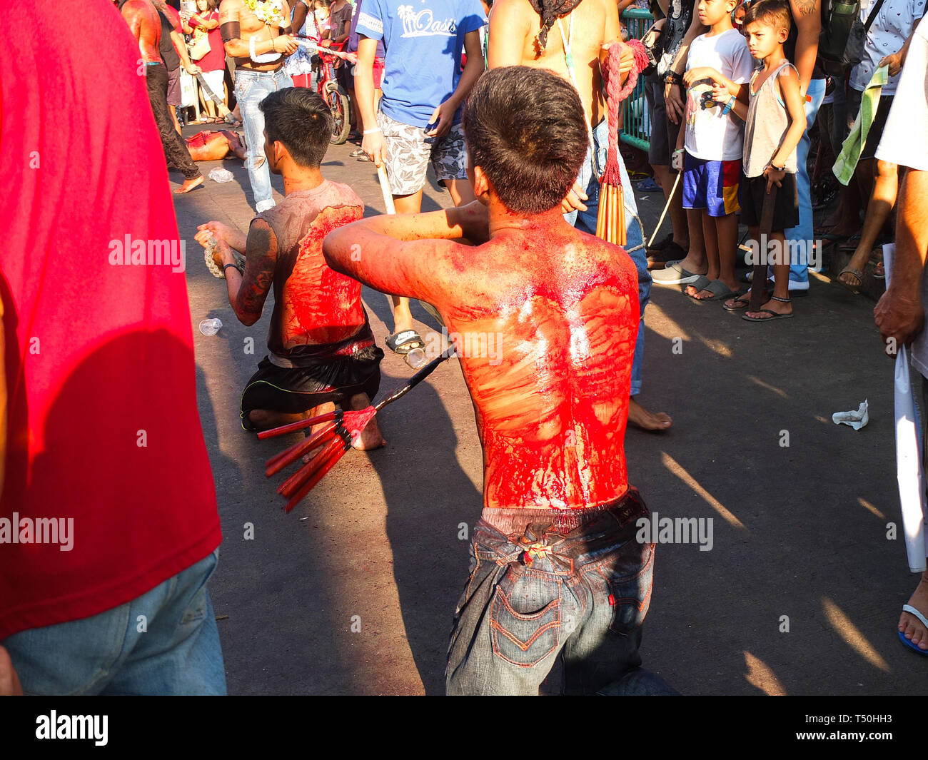 (EDITORS NOTE: Image contains graphic content) Back bloodied flagellates seen paraded on the streets of Navotas during Good Friday. Devout catholics in the deeply religious southeast asian nation of the philippines show their faith on good friday with self-flagellation or self-inflicting wounds,  imitating the suffering of christ. Stock Photo