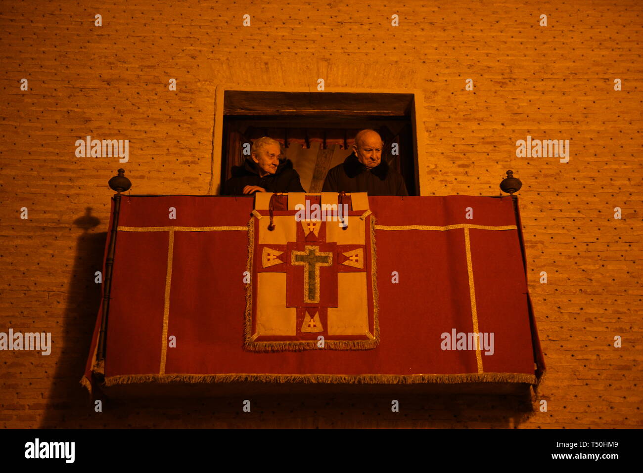 Believers seen watching from a building balcony during the procession of 'Viernes Santo' (Good Friday) in Soria, north of Spain. More than one billion Christian across the world mark the Holy Week of Easter in celebration of the crucifixion and resurrection of Jesus Christ. Stock Photo