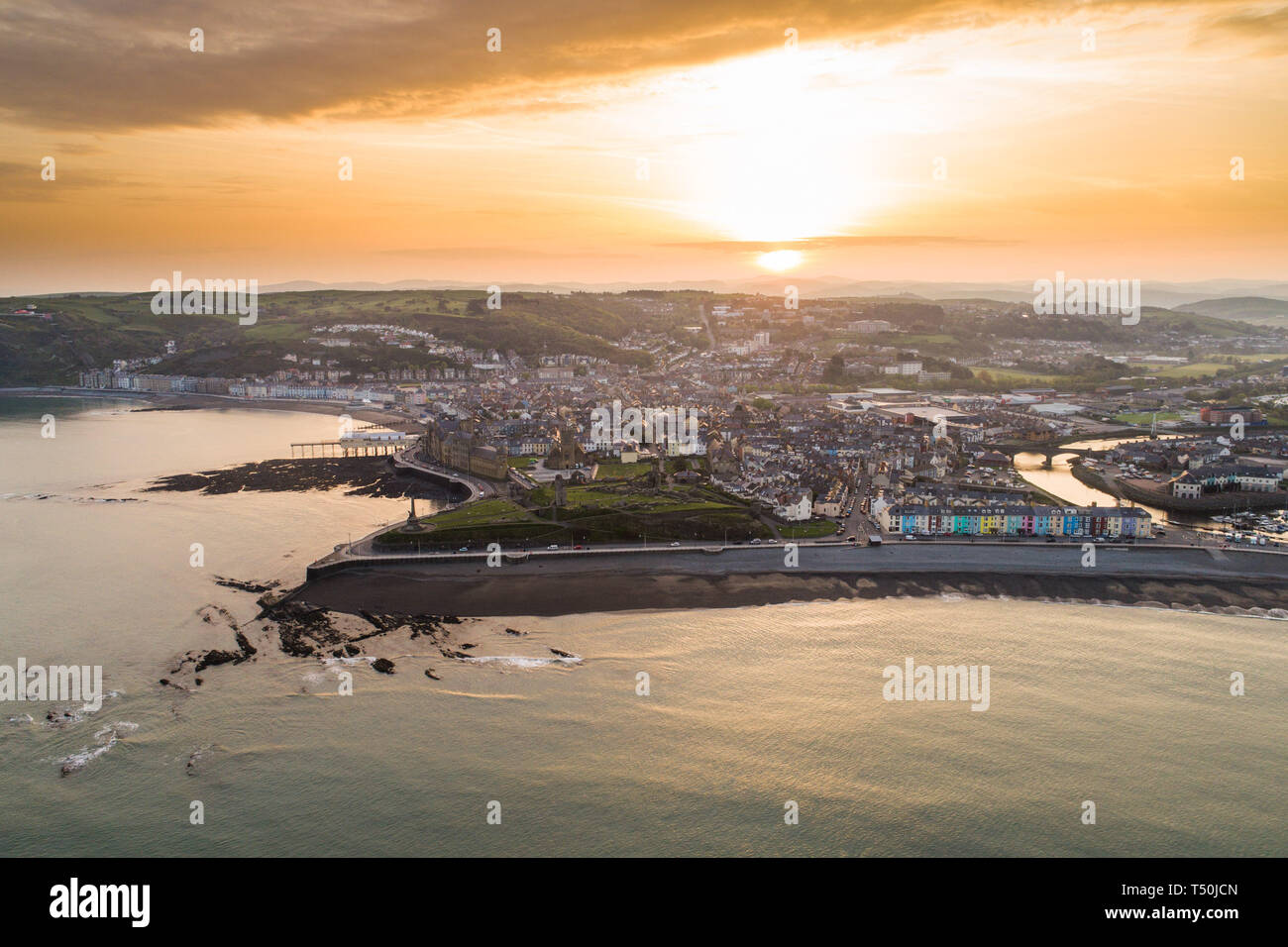 Aberystwyth Wales UK, Easter Saturday, 20 April 2019. UK Weather: Daybreak over the seaside and university town of Aberystwyth on the west wales coast, at the start of Easter Saturday 2019. The weather is again set to be hot and sunny, with temperatures in the low 20's Celsius (low 70's Fahrenheit). Aerial image by CAA approved and licenced drone operator photo Credit: Keith Morris/Alamy Live News Stock Photo