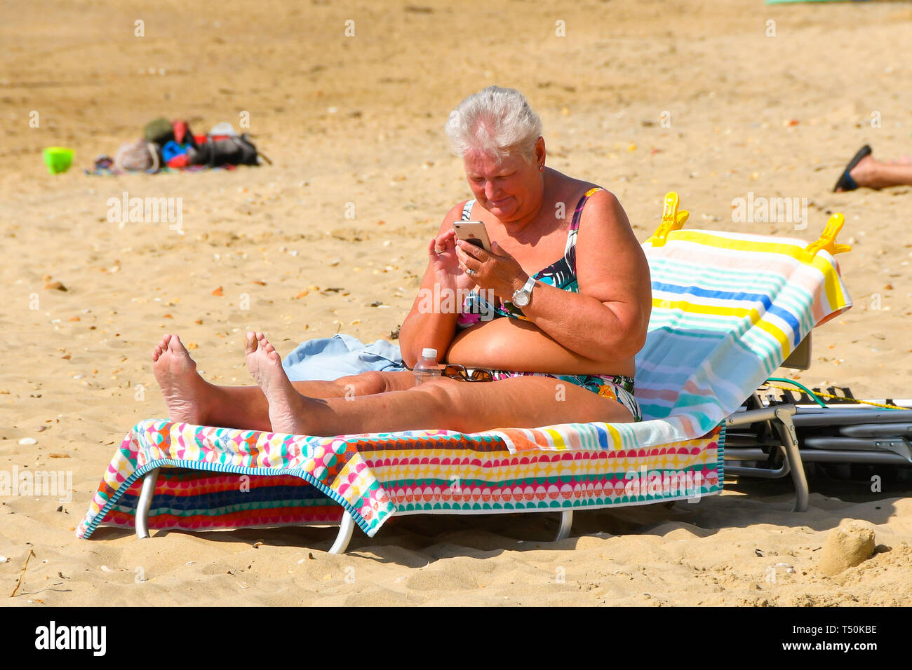 Bournemouth, Dorset, UK. 20th Apr, 2019. UK Weather. A sunbather topping up her tan on Boscombe Beach at Bournemouth in Dorset on another clear hot sunny day during the Easter weekend. Picture Credit: Graham Hunt/Alamy Live News Stock Photo