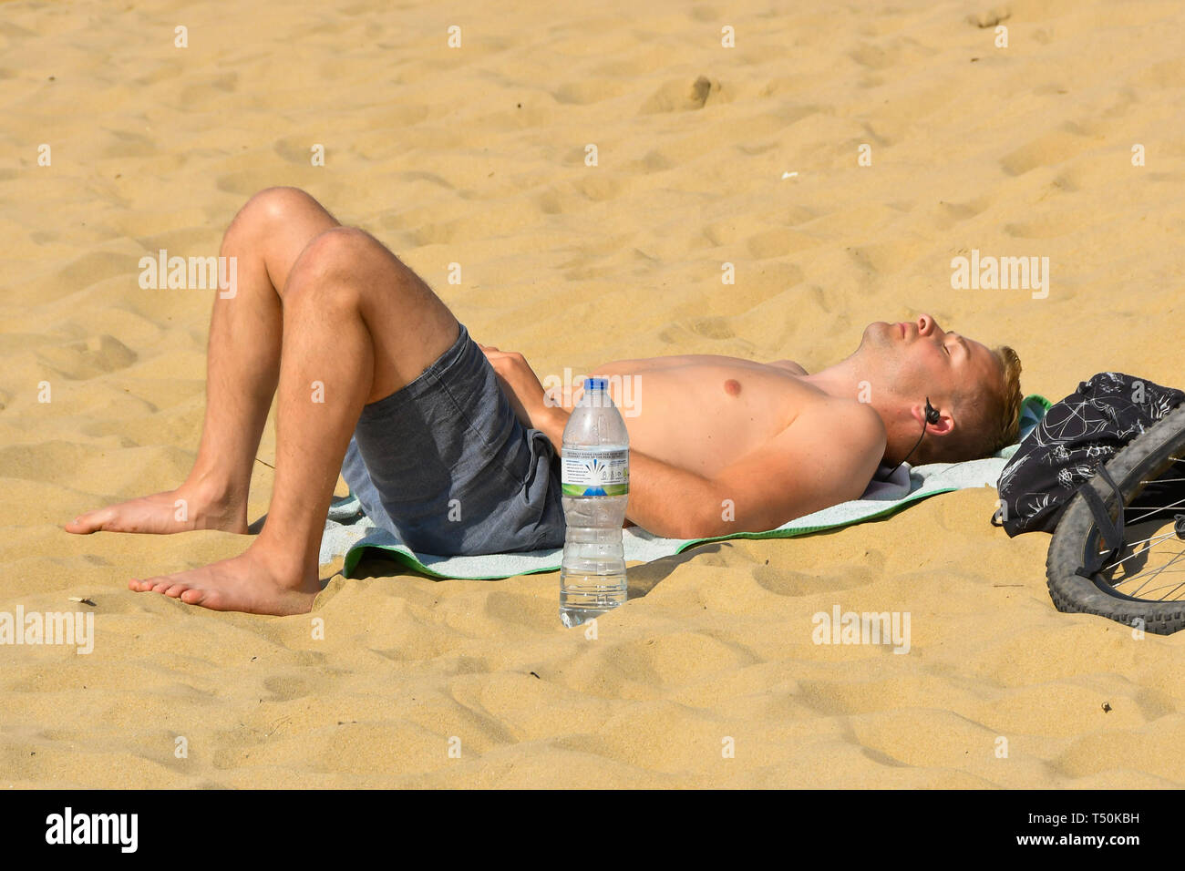 Bournemouth, Dorset, UK. 20th Apr, 2019. UK Weather. A sunbather topping up his tan on Boscombe Beach at Bournemouth in Dorset on another clear hot sunny day during the Easter weekend. Picture Credit: Graham Hunt/Alamy Live News Stock Photo