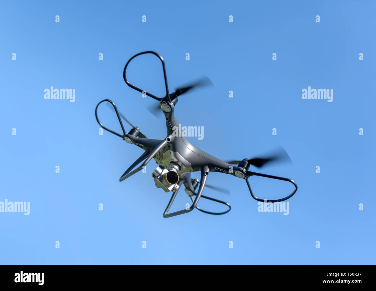 Drone in the sky. Unmanned aerial vehicle flying in the air Stock Photo ...