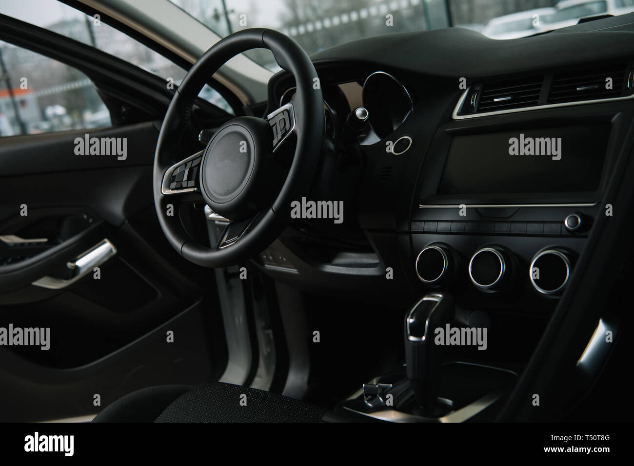 black steering wheel near manual transmission in luxury car Stock Photo
